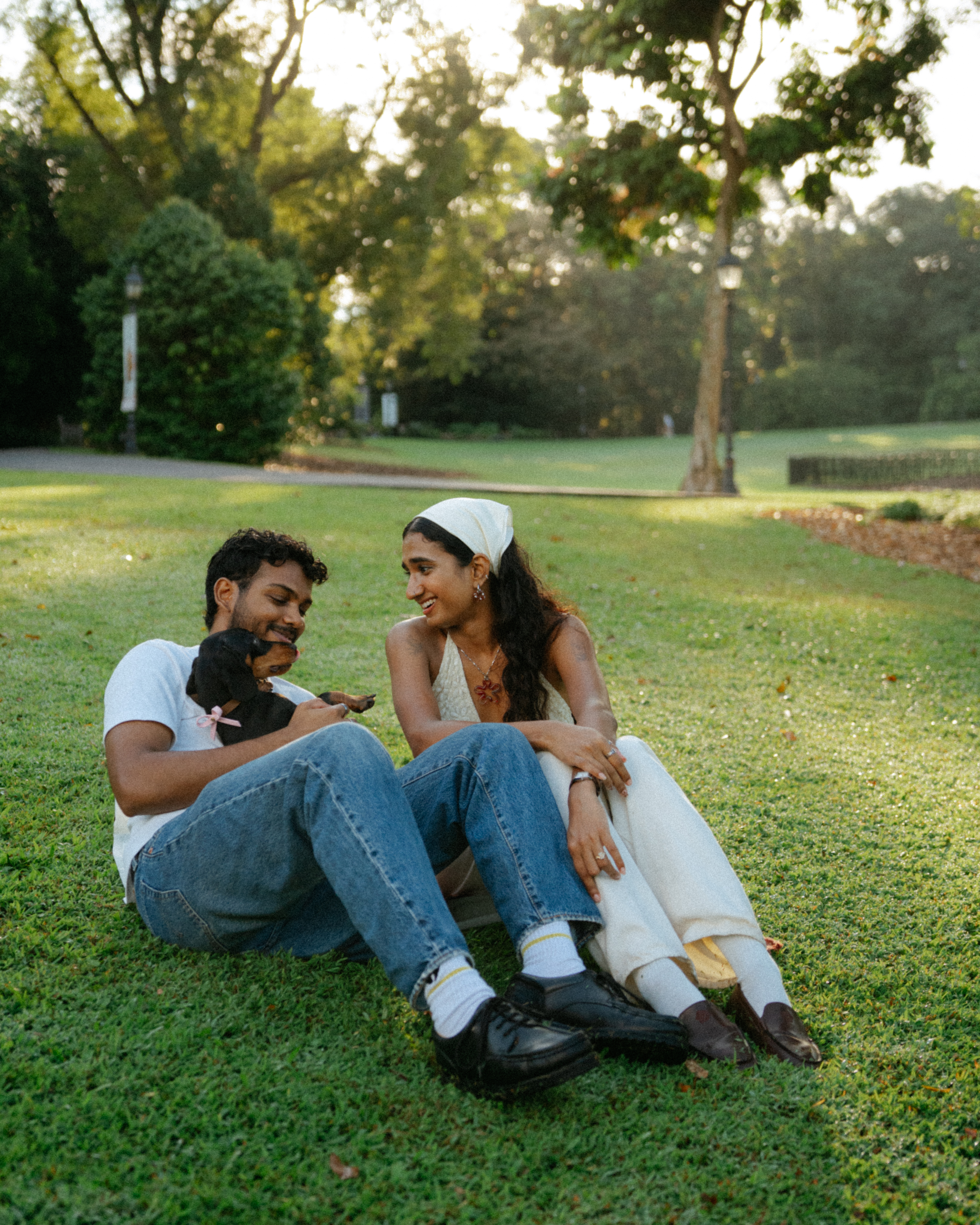 Janani and Dhanush sitting together outdoors