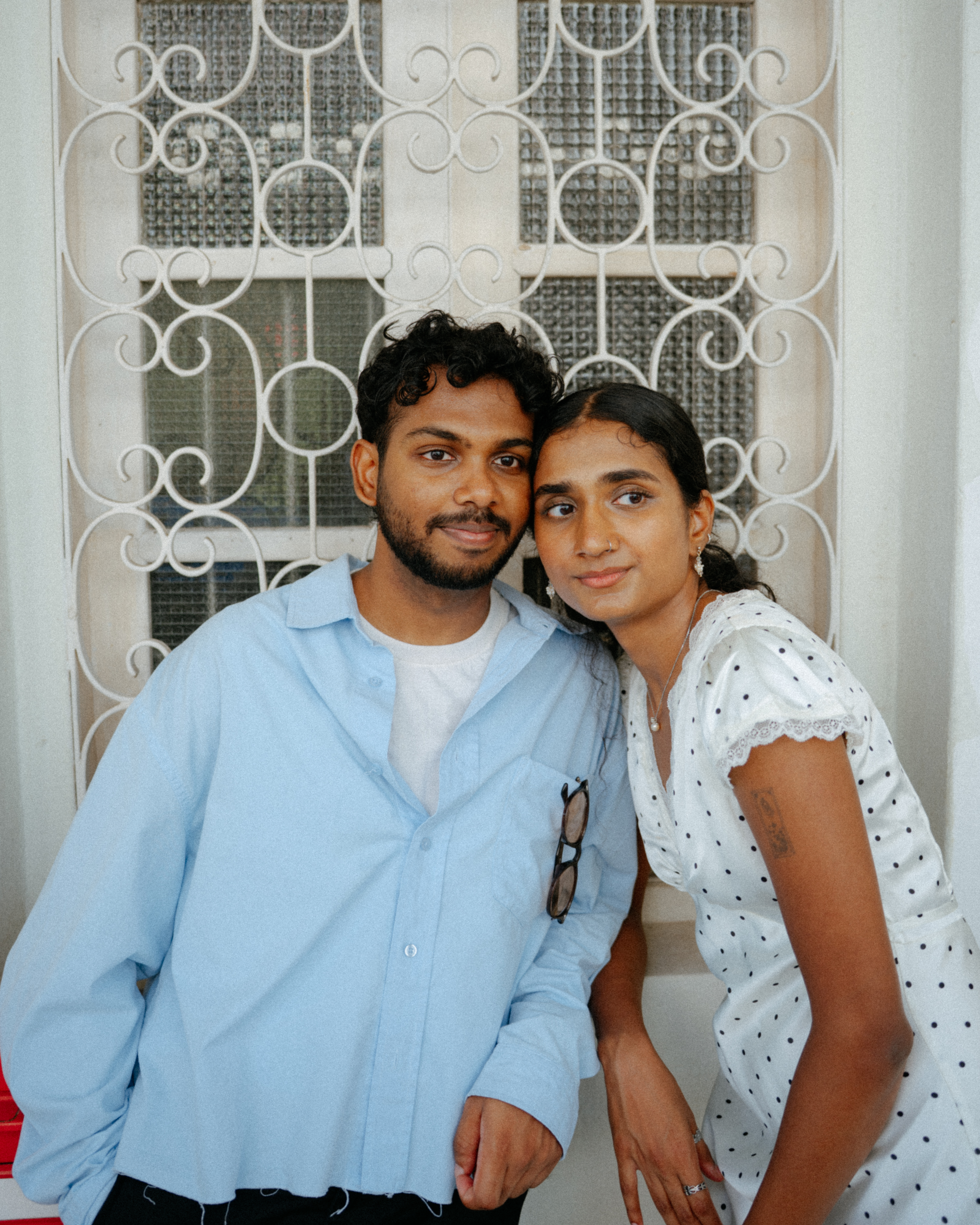 Janani and Dhanush standing together in the city
