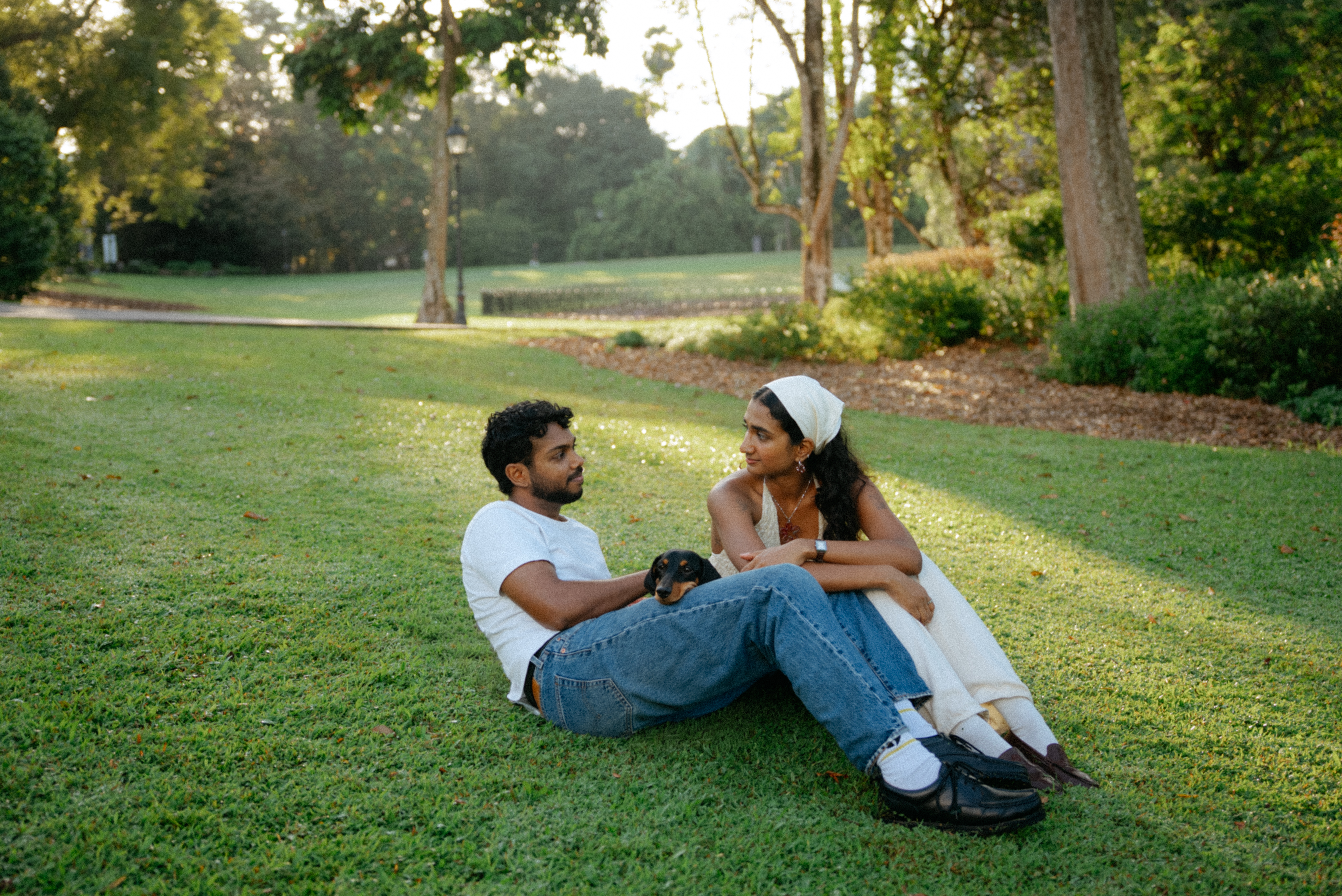 Janani and Dhanush relaxing together on the grass