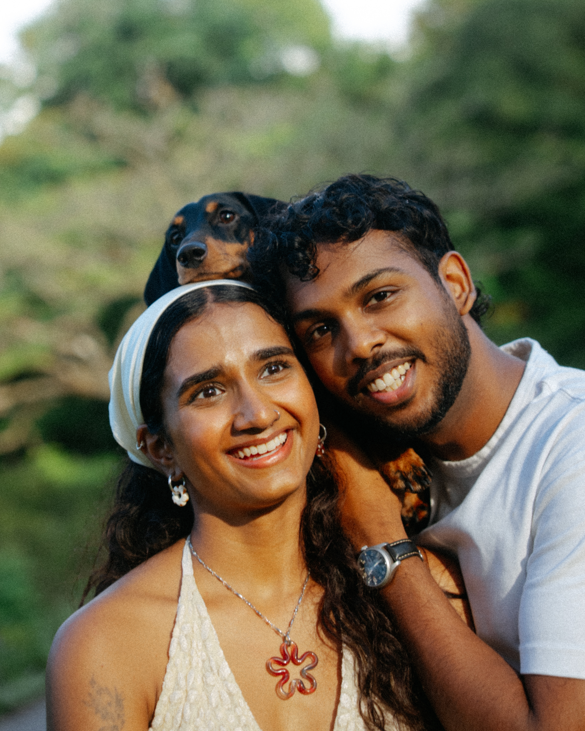 Janani and Dhanush holding their dog