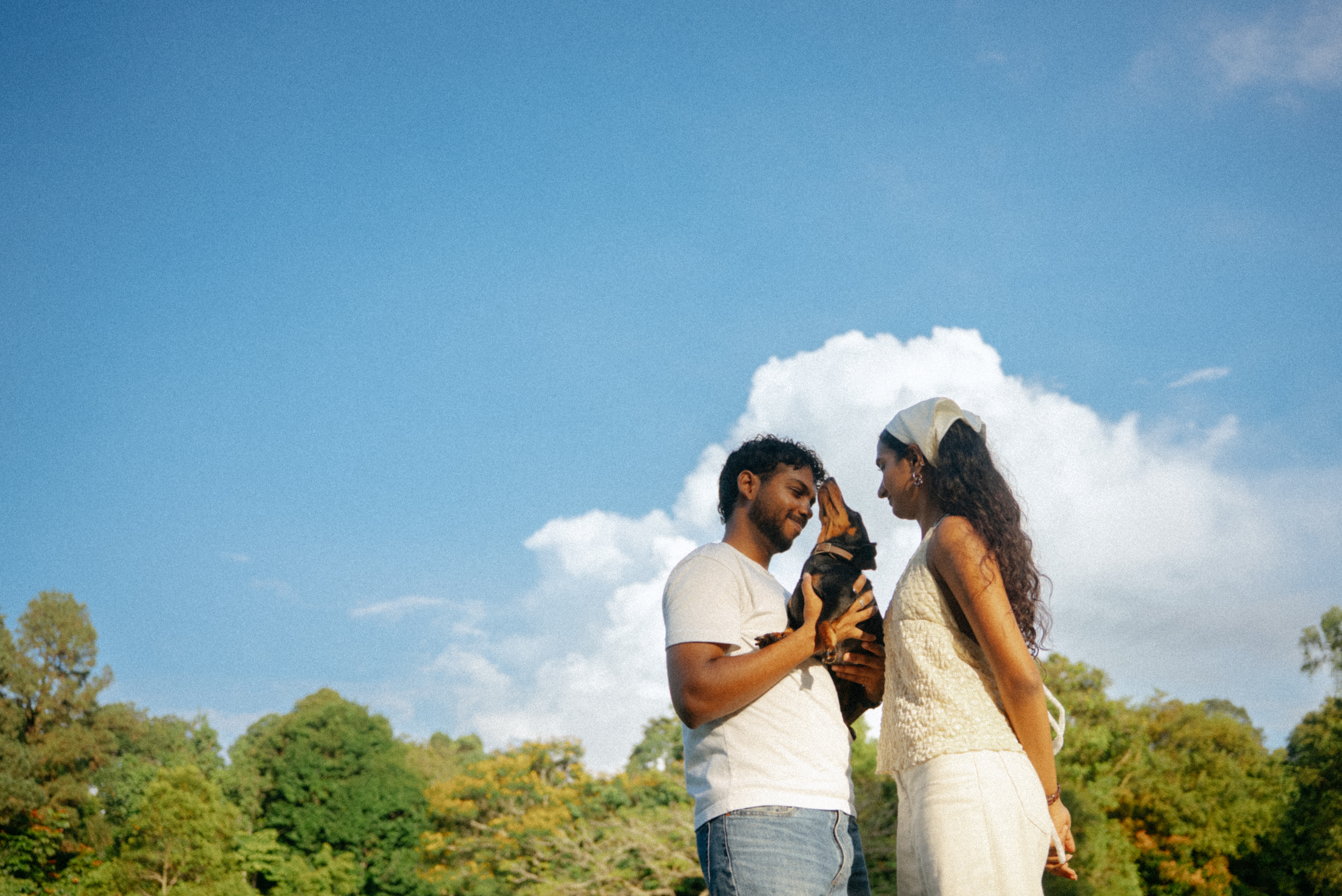 Janani and Dhanush outdoors in warm light
