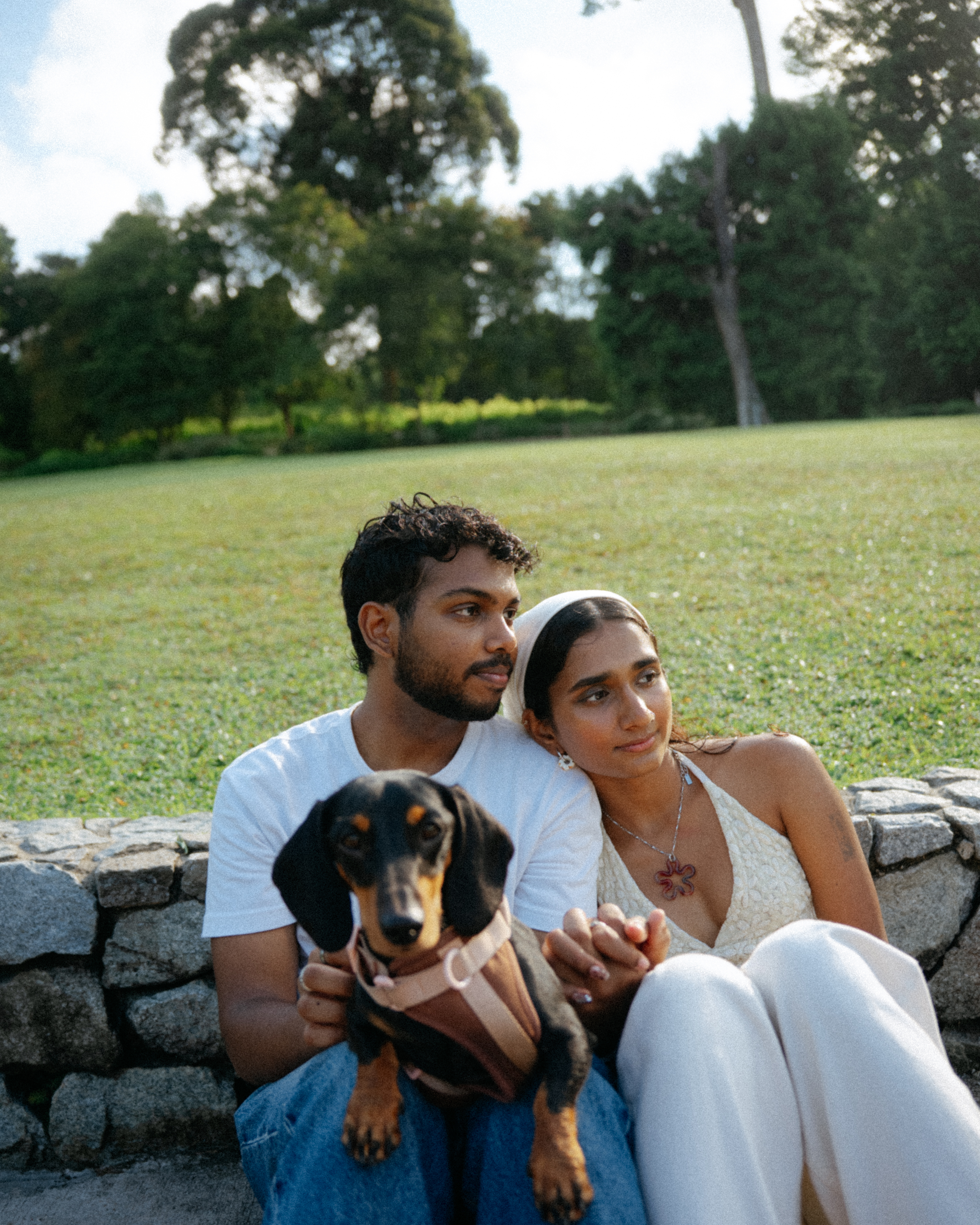 Janani and Dhanush playing with their dog in the park