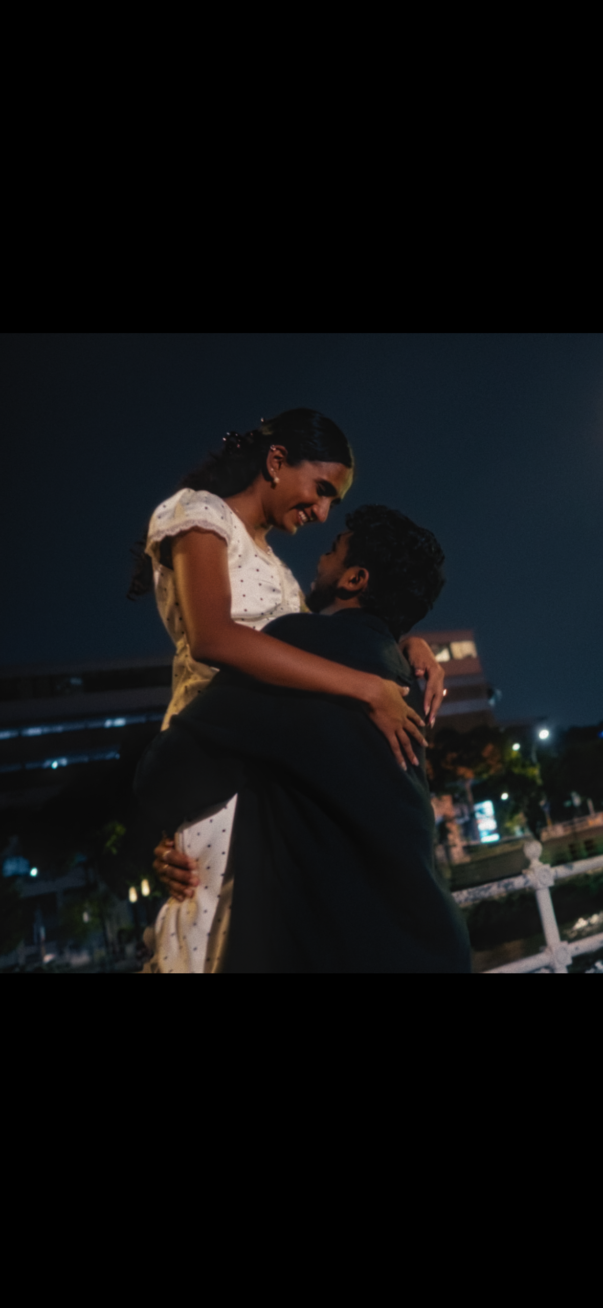 Janani and Dhanush in a vertical phone photo